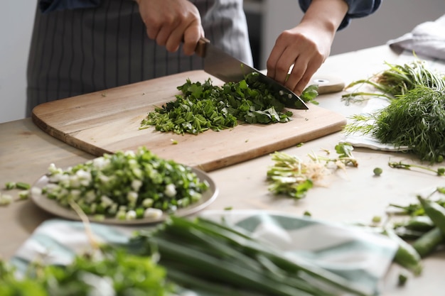 Cooking. Chef is cutting greens in the kitchen