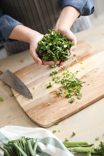 Cooking. Chef is cutting greens in the kitchen