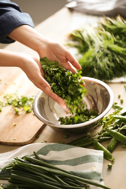 Cooking. Chef is cutting greens in the kitchen