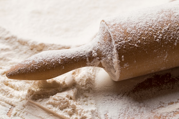 Cooking, close-up. Rolling pin in the flour