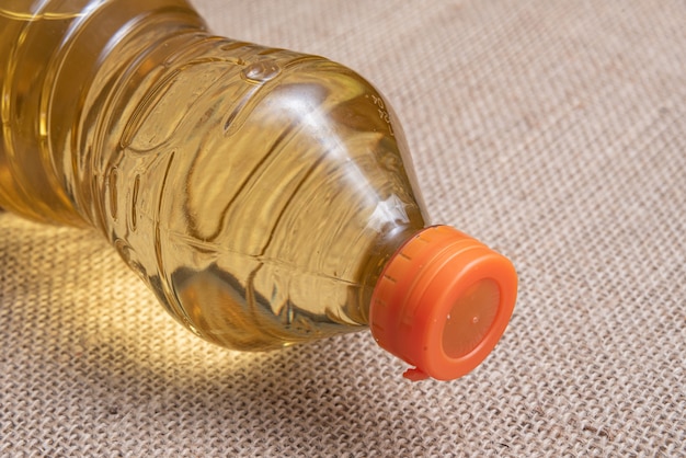 Cooking oil on the brown jute background