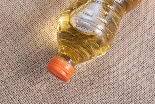 Free photo cooking oil on the brown jute background