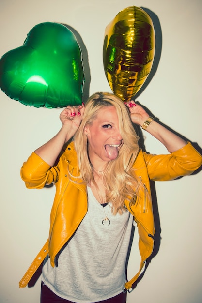 Free photo cool blonde joking with balloons