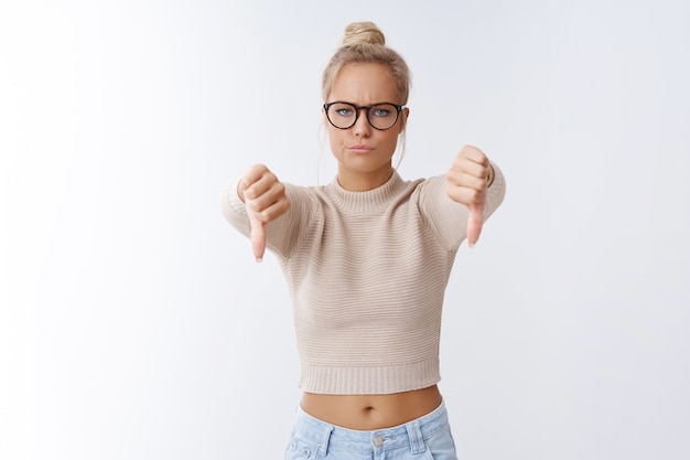 Free Photo not cool. displeased angry and upset serious-looking fed up girlfriend breaking-up with cruel disresprecful boyfriend showing thumbs down smirking in dismay frowning posing over white wall