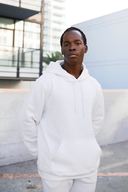 Cool man in white hoodie and sweatpants men's fashion apparel shoot