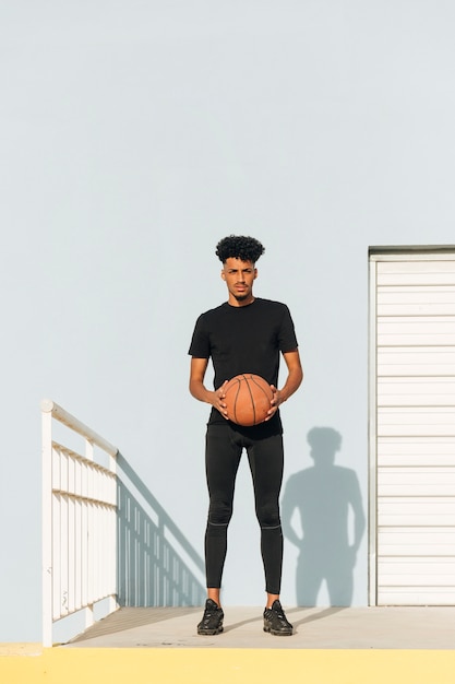 Free photo cool man with basketball on street