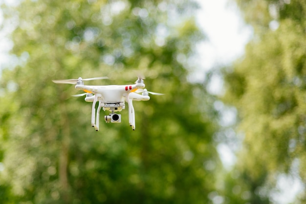 Copter with digital camera flying high in the air, taking photos