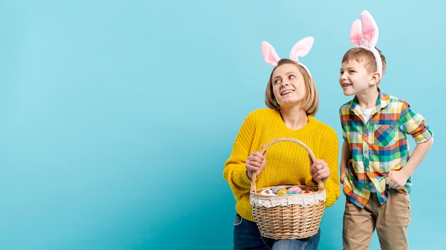 Copy-space mom with son holding painted eggs prepared for easter