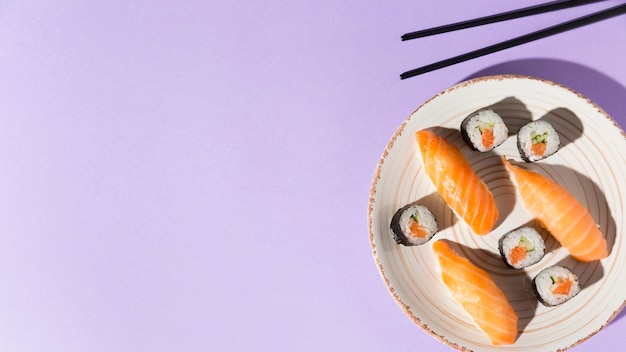 Free photo copy-space plate with delicious variety of sushi