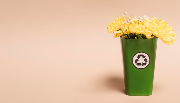 Copy space recycle bin with flowers