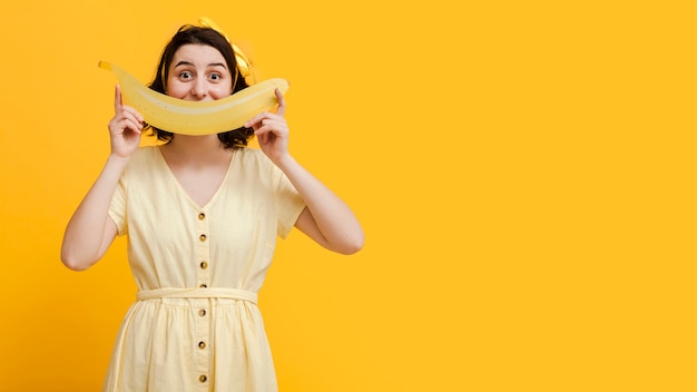 Copy-space woman with giant banana