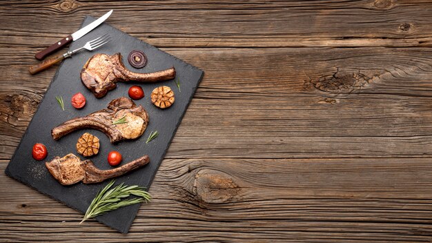 Copy-space wooden board with cooked meat