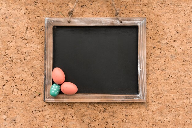 Cork background with slate and easter eggs