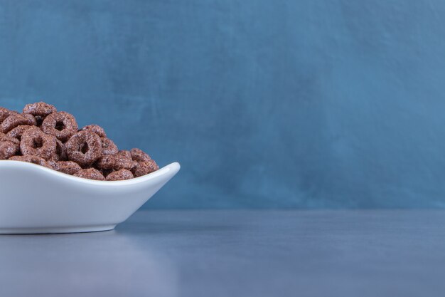 Corn rings in a bowl , on the marble background. High quality photo