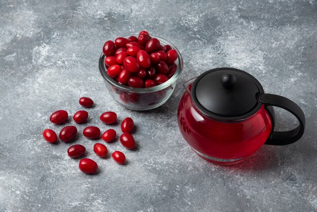 Cornel berries in the cup and juice in the kettle.