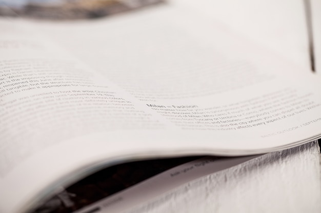 Free photo corner of a magazine on a white table