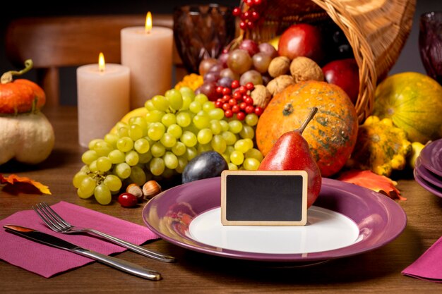 Cornucopia arrangement with delicious foods and empty blackboard