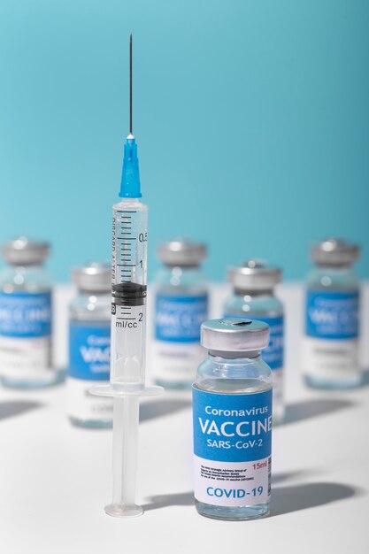 Coronavirus arrangement with vaccine bottle and syringe