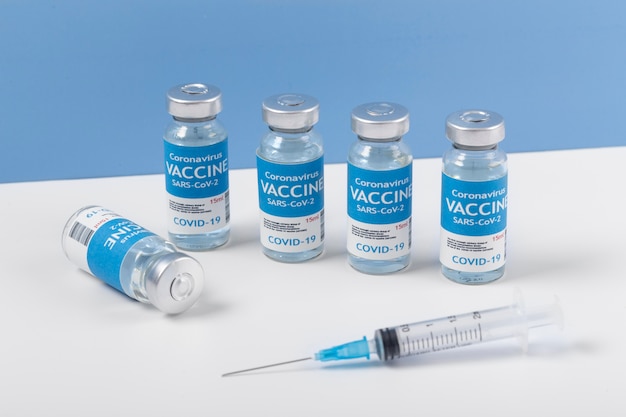 Coronavirus arrangement with vaccine bottle and syringe