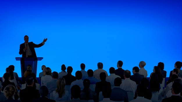 Free photo corporate businessman giving a presentation to a large audience