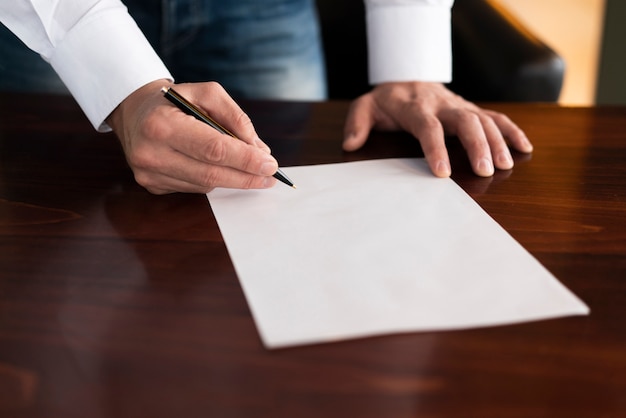 Free photo corporate employee writing on blank paper