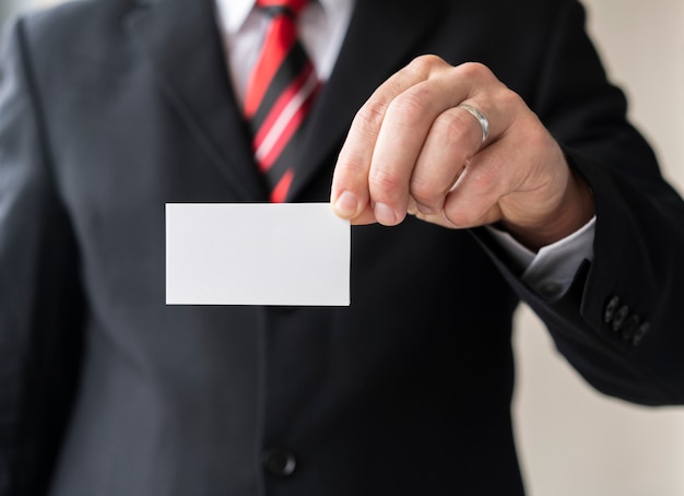 Free Photo corporate man holding blank business card