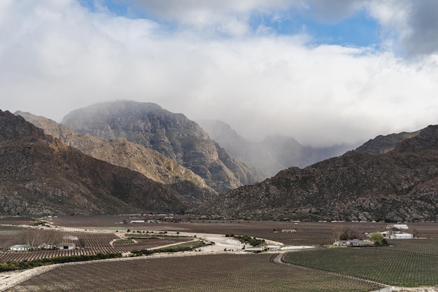 Free Photo countryside farmland with mountain backdrop