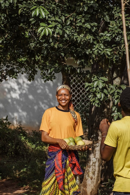 Free photo countryside woman holding fresh fruits