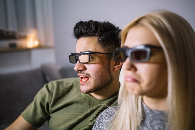 Couple in 3D glasses watching nice film