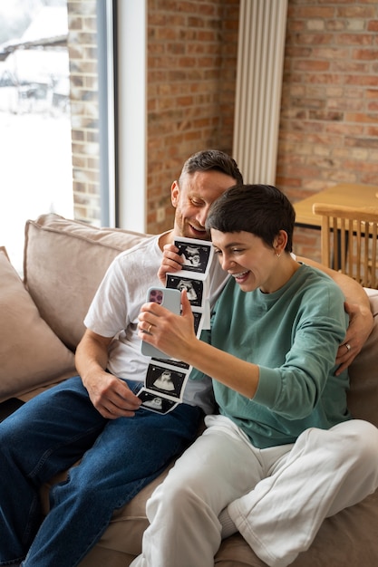 Couple announcing pregnancy during a videocall