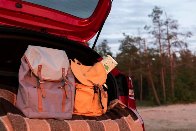 Couple backpacks in the trunk with copy space