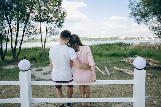 Couple of backs sitting on a white fence