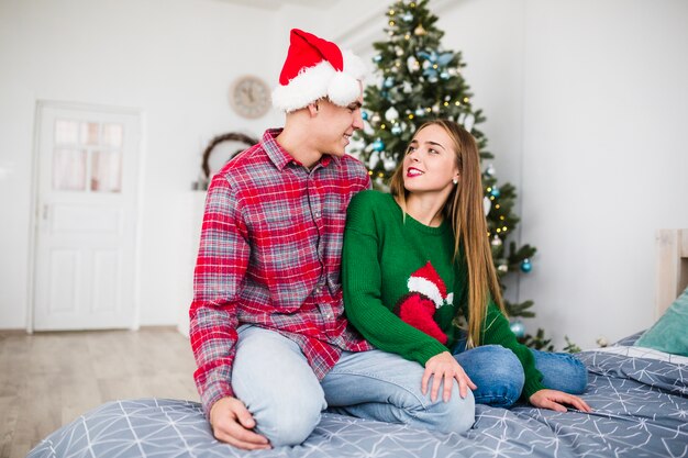 Couple on bed at christmas