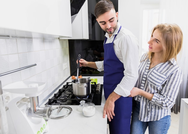 Free photo couple boiling water in pot