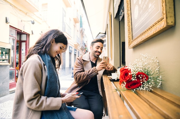 Couple browsing smartphones on date