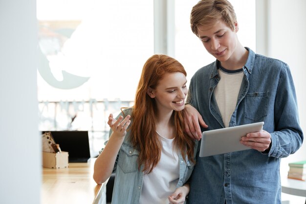 Couple in cafe using tablet