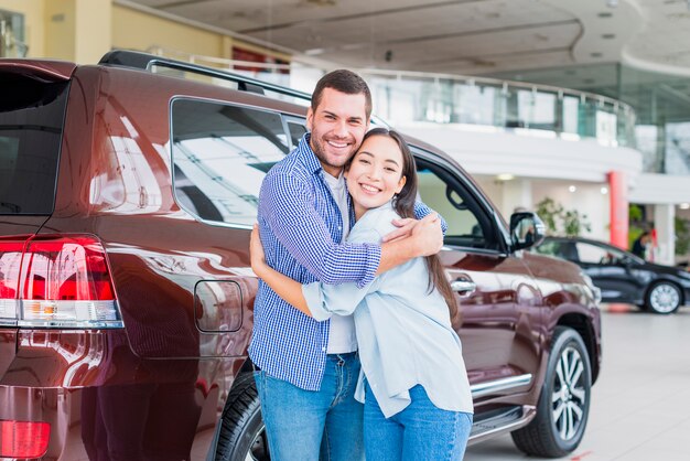 Couple in car dealership