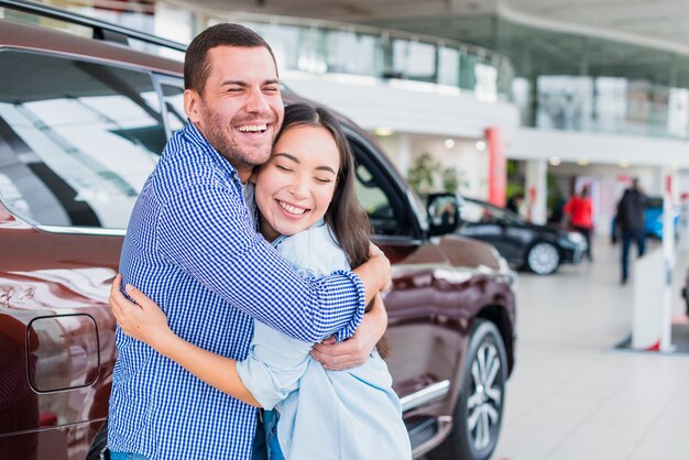 Couple in car dealership