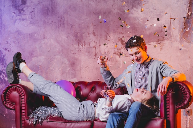 Free Photo couple celebrating with champagne and confetti