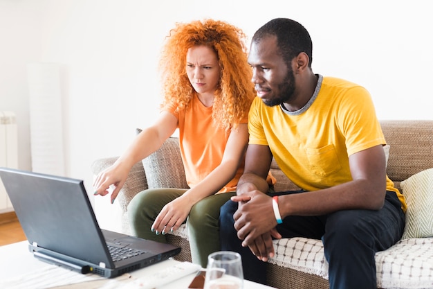 Free photo couple checking something on a laptop