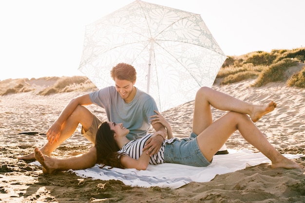 Free photo couple chilling on beach