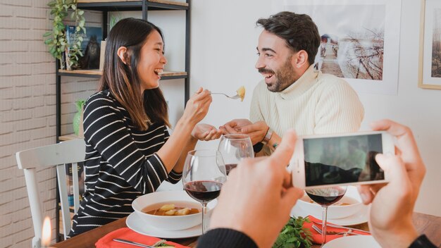 Couple at christmas dinner through smartphone