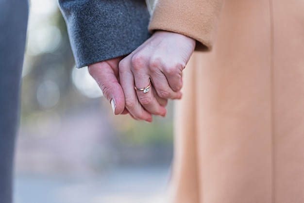 Couple in coats holding hands 