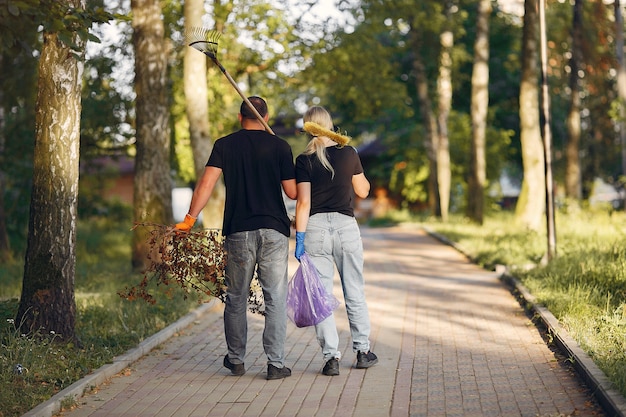 Couple collects leaves and cleans the park