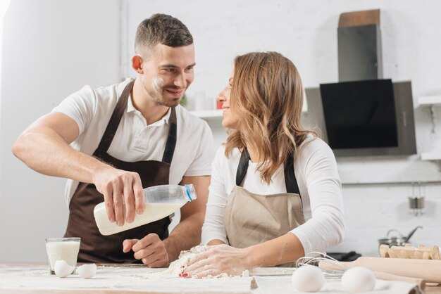 Couple cooking cake together