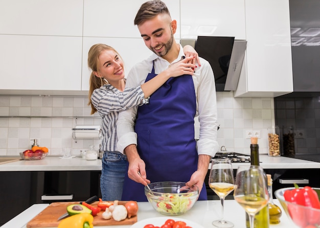 Free photo couple cooking salad in kitchen