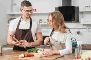 Free photo couple cooking with tablet at home