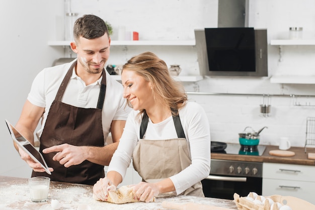 Couple cooking with tablet