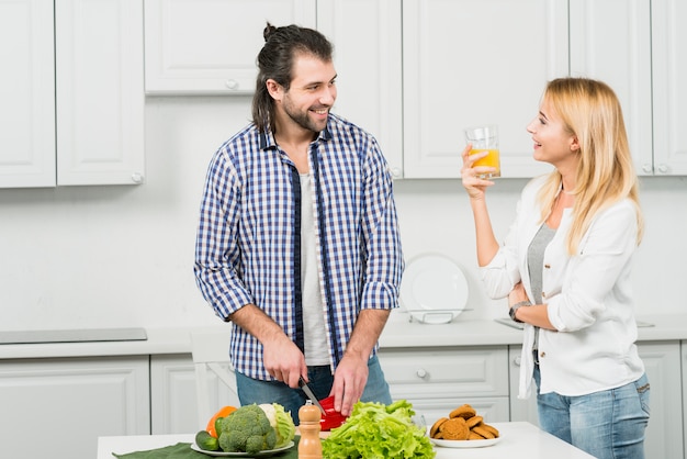 Couple cutting vegetables