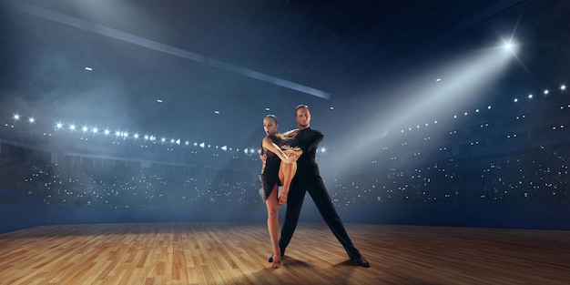 Free Photo couple dancers perform latin dance on large professional stage ballroom dancing